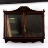 A mahogany framed wall hanging display cabinet with mirror back and glazed front and sides,