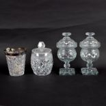 A pair of cut glass confitures and covers on square pedestal bases, 25cm high,