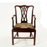 A George III style mahogany open armchair, with serpentine top rail,