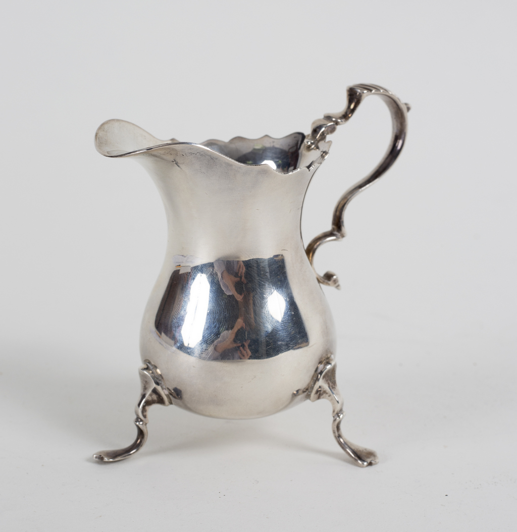 A silver helmet-shaped cream jug, JBC & Son Ltd.