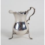 A silver helmet-shaped cream jug, JBC & Son Ltd.