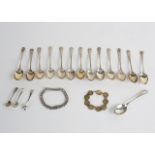 Thirteen silver teaspoons, a silver identity bracelet and a bracelet of silver threepenny pieces,
