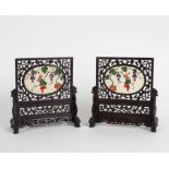 A pair of Chinese table screens each with oval scene of a squirrel among fruiting branches in