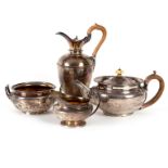 A matched silver tea and coffee service, comprising a William IV hot water jug, William Eaton, 1834,