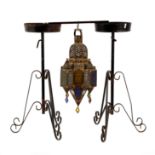 A pierced brass Turkish hanging lantern with coloured glass panels,