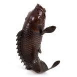 A Japanese bronze model of a leaping fish, Meiji period, signed under,