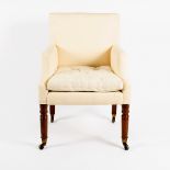 A George IV oak framed upholstered armchair, on turned feet with brass castors,