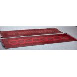 Two modern Afghan rugs on a red ground,