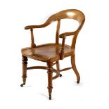 A Victorian bleached walnut elbow chair with dished seat on turned legs united by a crinoline