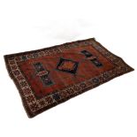 A kilim rug with geometric designs to a camel ground, 180cm x 111cm and a small Eastern rug,