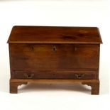 A 19th Century oak coffer bach, the hinged lid enclosing a candle box,