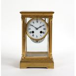 A gilt brass cased four-glass clock, the enamel dial with Roman numerals,