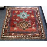 A small Kazak rug, West Caucasus, late 19th Century, the red field with two stepped gul medallions,