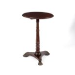 A Victorian circular table on a turned column and flat tripod support,