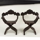 A pair of Italian carved Savonarola type folding chairs