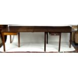 A George III mahogany two-flap dining table, raised on square taper legs, 143.