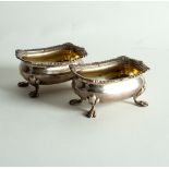 A pair of 18th Century style silver salts, with gadrooned rims on paw feet, 10cm wide,