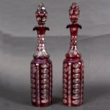 A pair of ruby stained clear flash decanters and stoppers,
