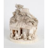 A Japanese Meji period carved ivory cottage,