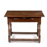 A late 17th Century oak table, fitted a single drawer on turned legs with stretchers,