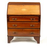 An Edwardian mahogany bureau fitted three drawers,