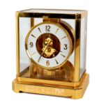 An Atmos clock by Jaeger-LeCoultre, in a gilt brass case with glazed top and sides, 23.