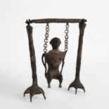 An Indian carved bronze and wirework figure of a woman on a swing, the supports with claw feet,