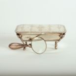 A silver dressing table box with hinged cover and ram masks to the corners, on hoof feet,