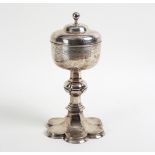 A silver plated covered chalice, the domed cover with plain finial,