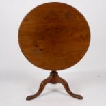 A George III mahogany supper table, the circular tilt top on fluted column and tripod support,