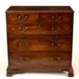 A George III mahogany chest of three long and two short drawers with brushing slide,