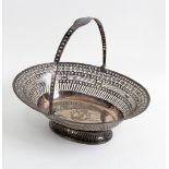 A Sheffield plate pierced cake basket with swing handle and central crest,