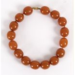 An amber necklace of large slightly oval beads,