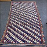 A Kuba long rug, East Caucasus, circa 1890, the field of ivory and indigo,