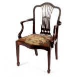 A George III mahogany open armchair, with serpentine shaped top rail and seat,