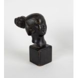 An Indian bronze bust of a woman, her hair tied in a bun, on a rectangular base,