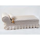 A modern chaise longue, cream and gold upholstery,