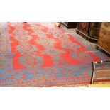 A large Turkey carpet, with geometric design in green and blue to a crimson ground, damages,