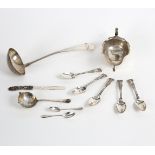 A silver sauce boat, EV, Sheffield 1939, on three scroll feet, a ladle,