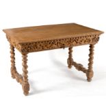 A 17th Century style oak table with carved frieze and fitted a drawer on spiral turned legs,