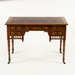 An Edwardian walnut writing table, Jas Shoolbred & Co., no.