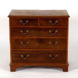 A George III mahogany chest of two short over three long drawers on bracket feet,