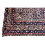 A large Fereghan carpet, circa 1900, the blue herati field within multiple floral borders,