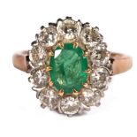 An emerald and diamond cluster ring, the oval emerald to a surround of ten diamonds,