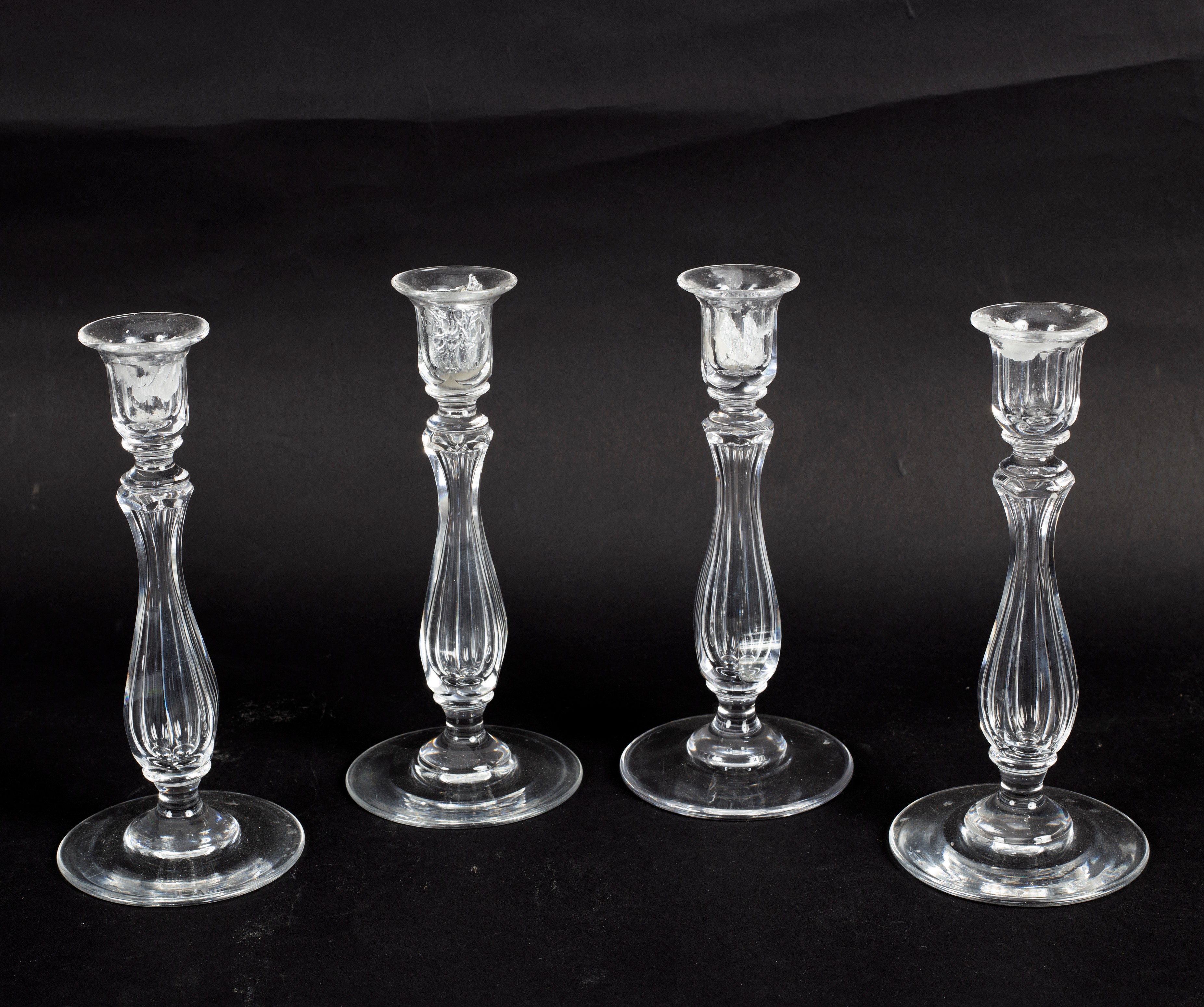 Four late 19th Century cut glass candlesticks of fluted baluster form,