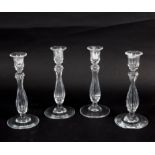 Four late 19th Century cut glass candlesticks of fluted baluster form,