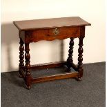 An oak table with shaped frieze on baluster turned legs,