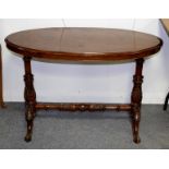 A Victorian walnut and inlaid oval table on carved end supports and cabriole legs,