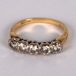 A diamond five-stone ring, claw set in white metal to an 18ct yellow gold shank,