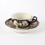 An 18th Century Worcester cup and saucer painted exotic birds in gilt reserves, 13cm diameter,